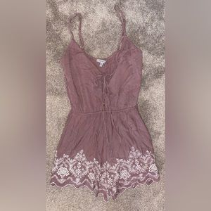 Blush romper with floral trim